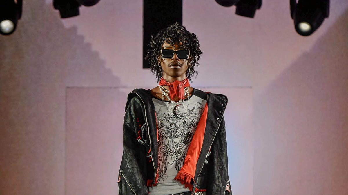 Ornate black and red jacket with a red scarf beneath the projected pyramid