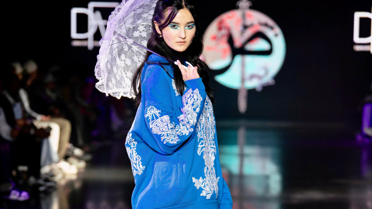 Blue baroque-embroidered hoodie carried with a lace parasol at Denver Fashion Week
