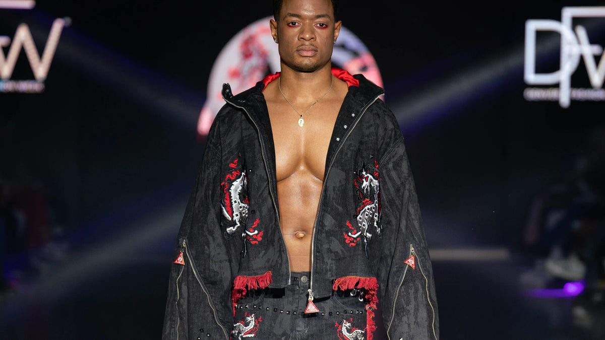 Black denim jacket with red trim held open on the Denver runway