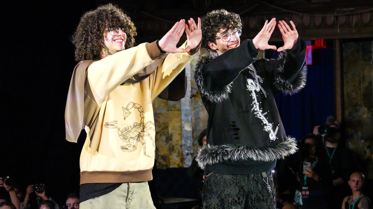 Maddox Albright and Arman Sadeghi raise their hands into the shape of the house pyramid as the New York show closes