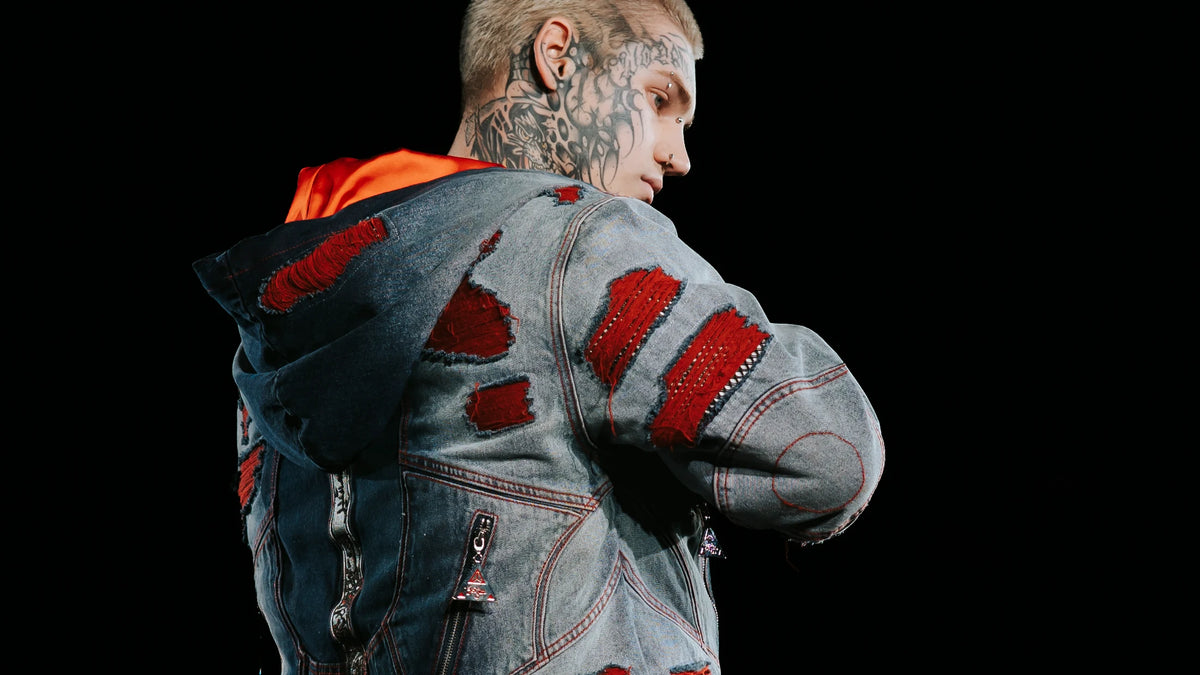 The Slasher denim set from behind on Runway 7 in New York, slashed panels backed in red