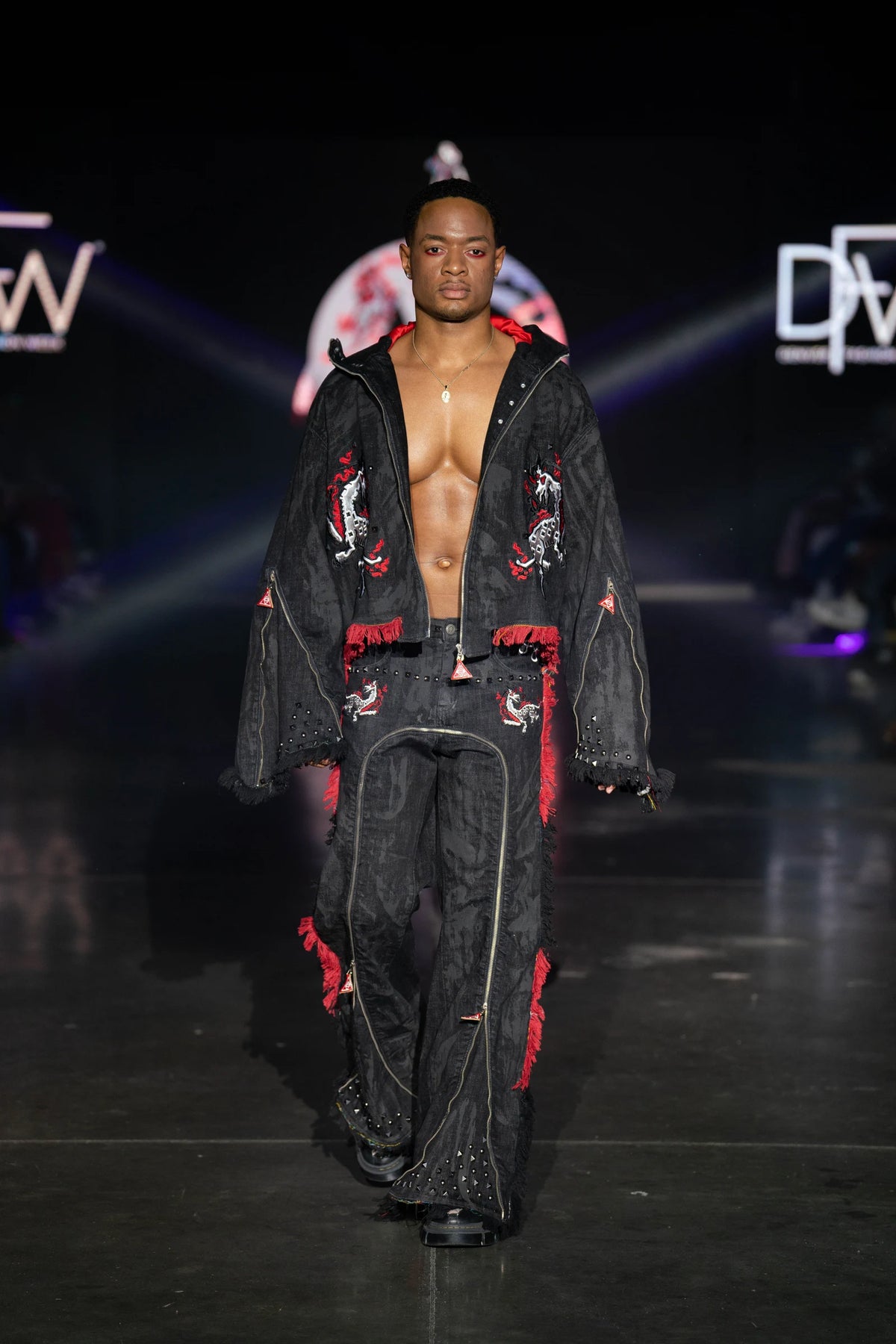 The black waxed denim set on the Denver Fashion Week runway, jacket open over the red lining